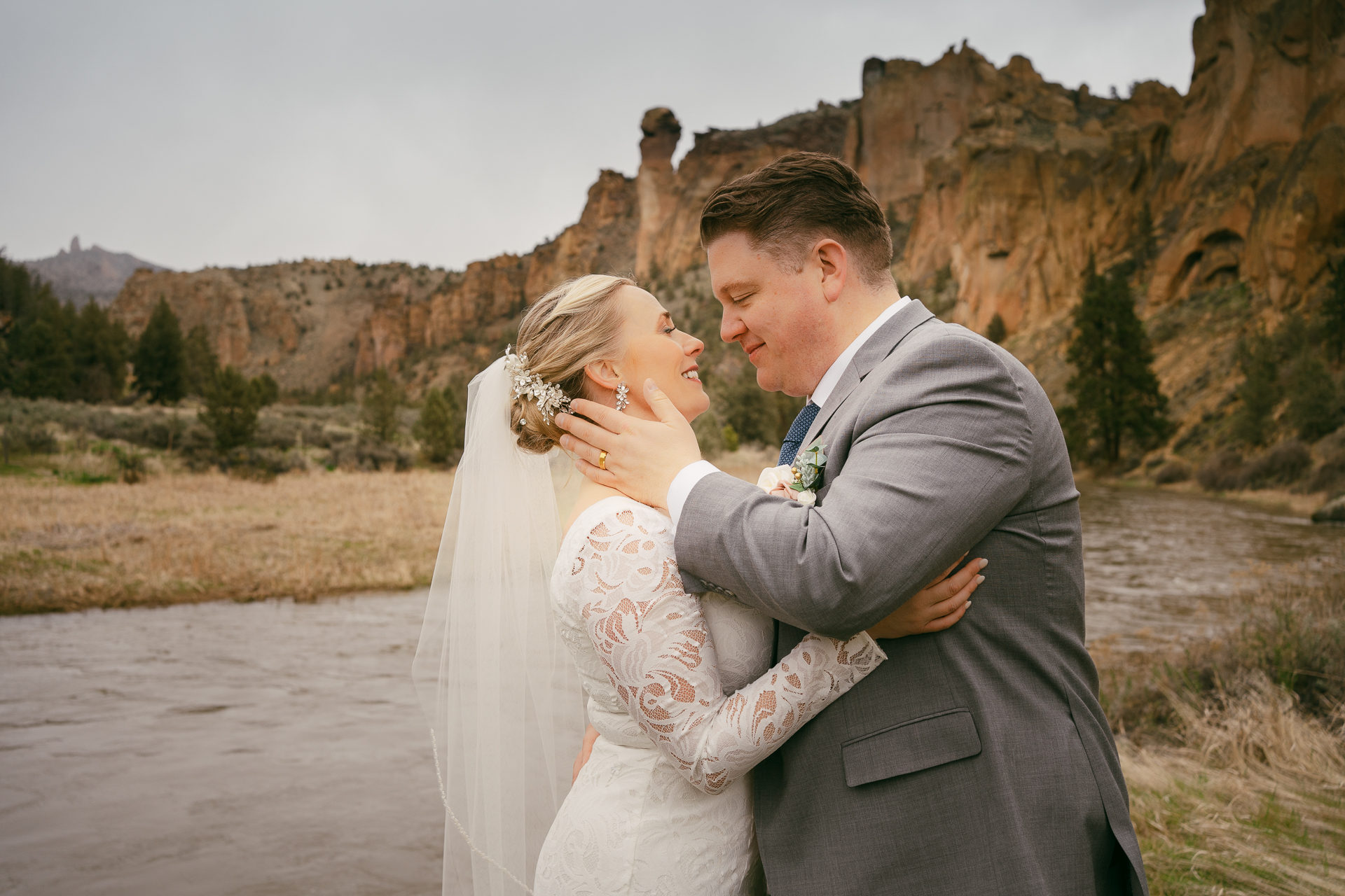 Matt & Christy gazing into each other's eyes after exchanging their vows in front of the river and cliffs during their Smith Rock elopement.